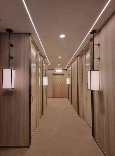 The front door makes a bold design statement at the end of the elegant corridor