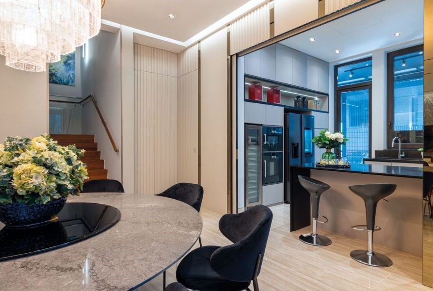 Photo 2 of 3 The dry kitchen can be hidden away behind telescopic fluted-glass doors or left open for guests to mingle around the island